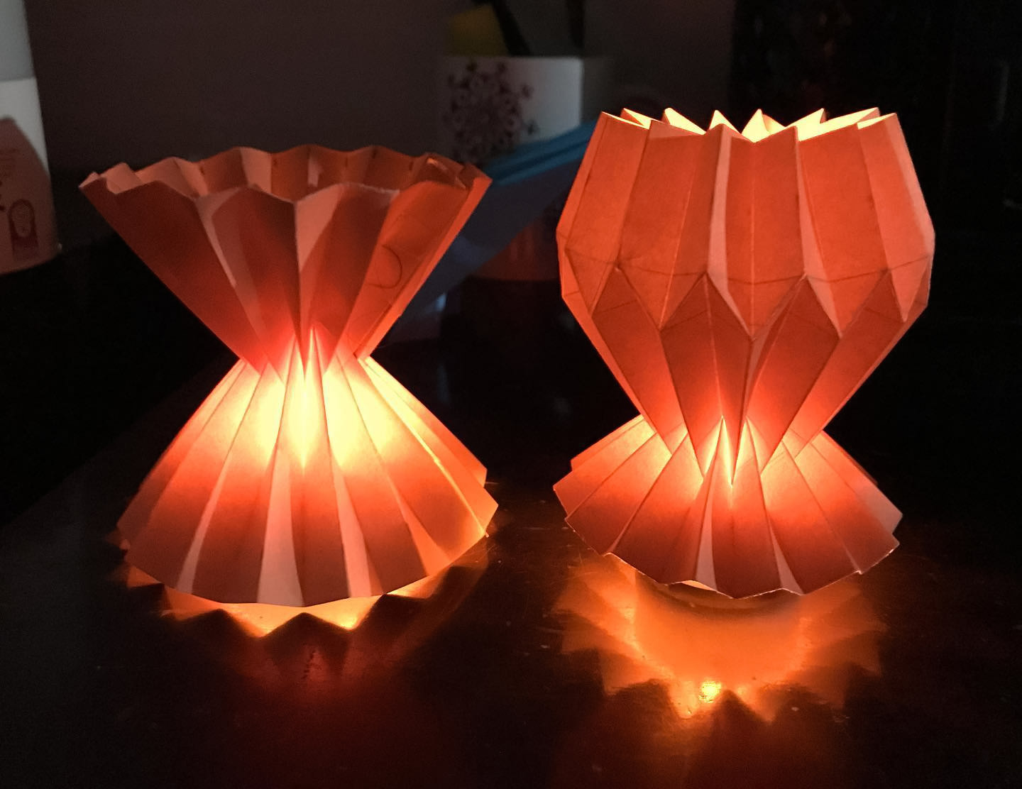 Two orange origami lights