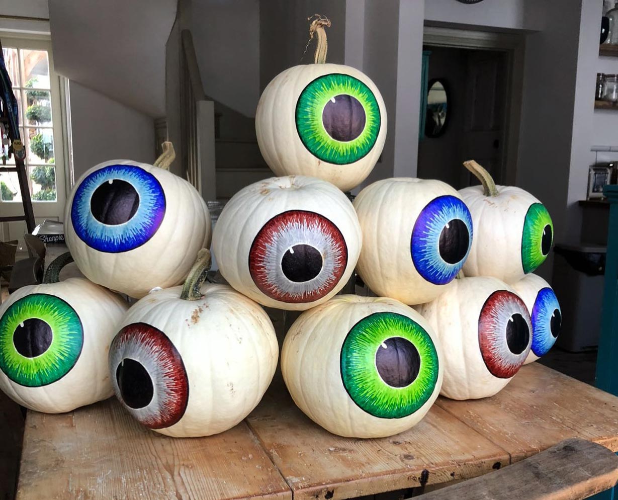 Many pumpkins painted like eyeballs