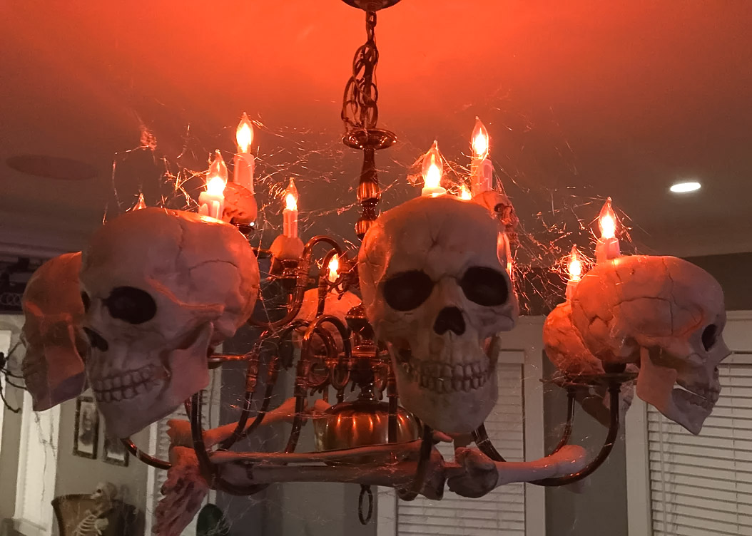 Lit creepy skulls chandelier