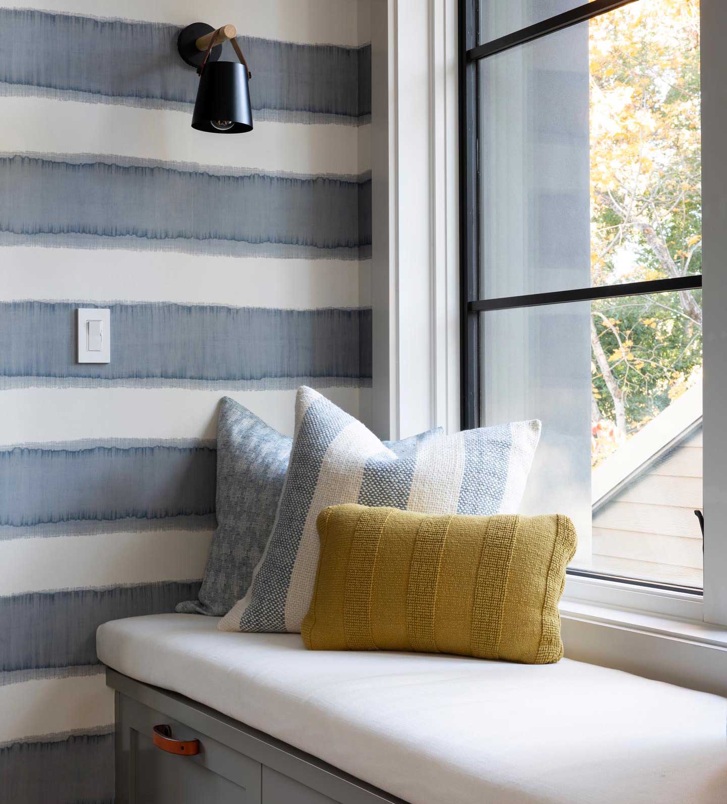 Interior with horizontally striped wall and pillows