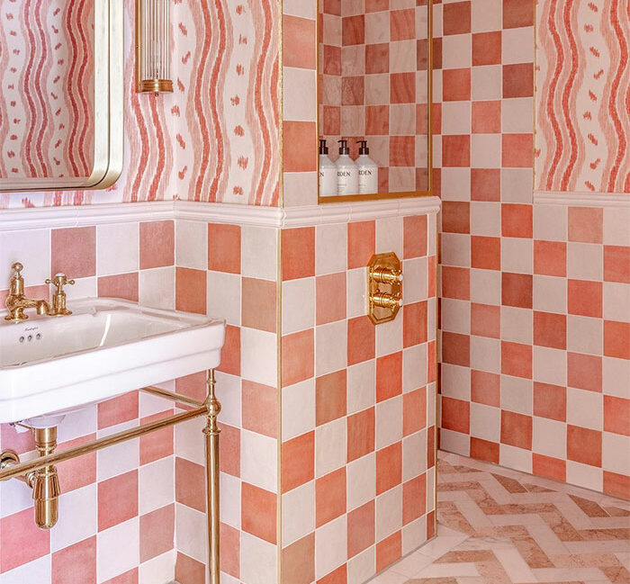 sweet bathroom with pink tiles and abstract wall design
