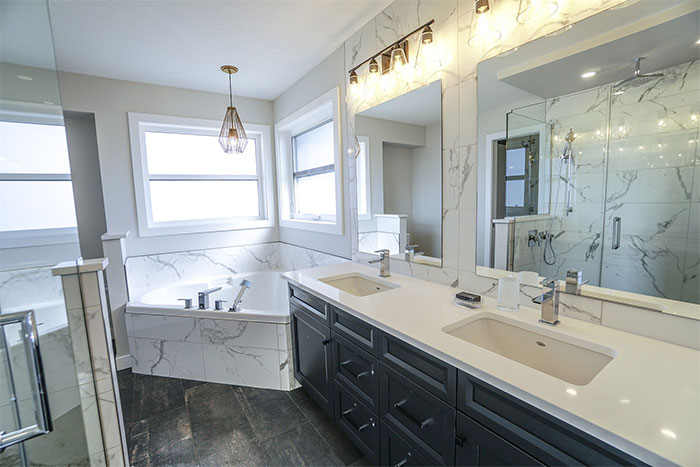 bathroom with white marble tiles on walls, floors and sinks