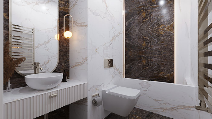 a bathroom with a tub sink and toilet and marble walls