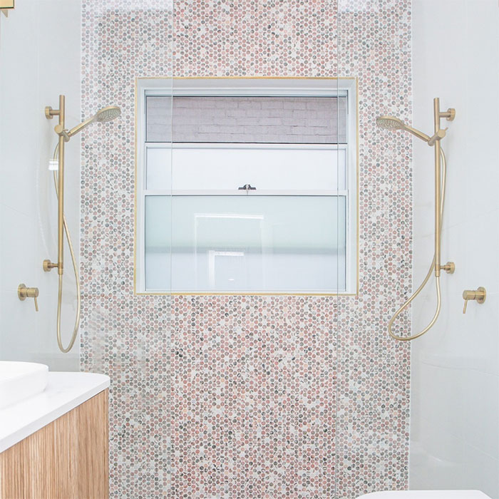 bathroom with colorful hexagon mosaic tiles on shower wall