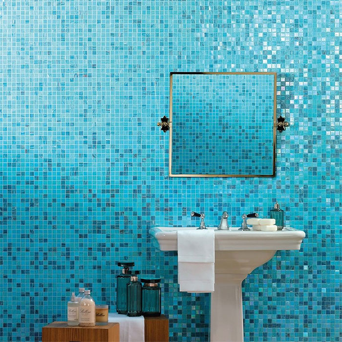 bathroom with blue mosaic tiles on wall and sink
