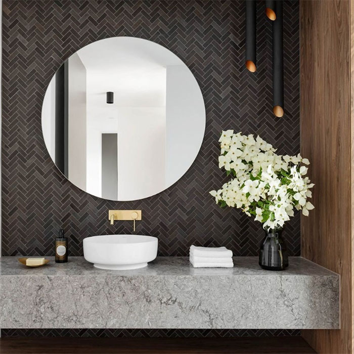 bathroom with herringbone tiles wall and sink