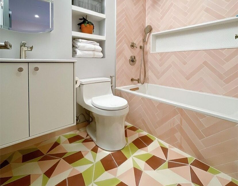 bathroom with mosaic floors and pink tile walls