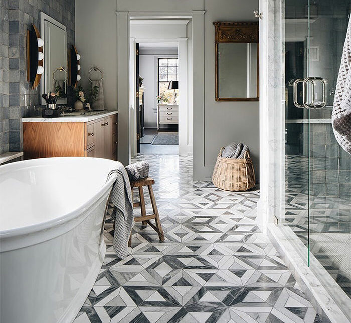 bathroom with geometric gray white tiles floor with sink