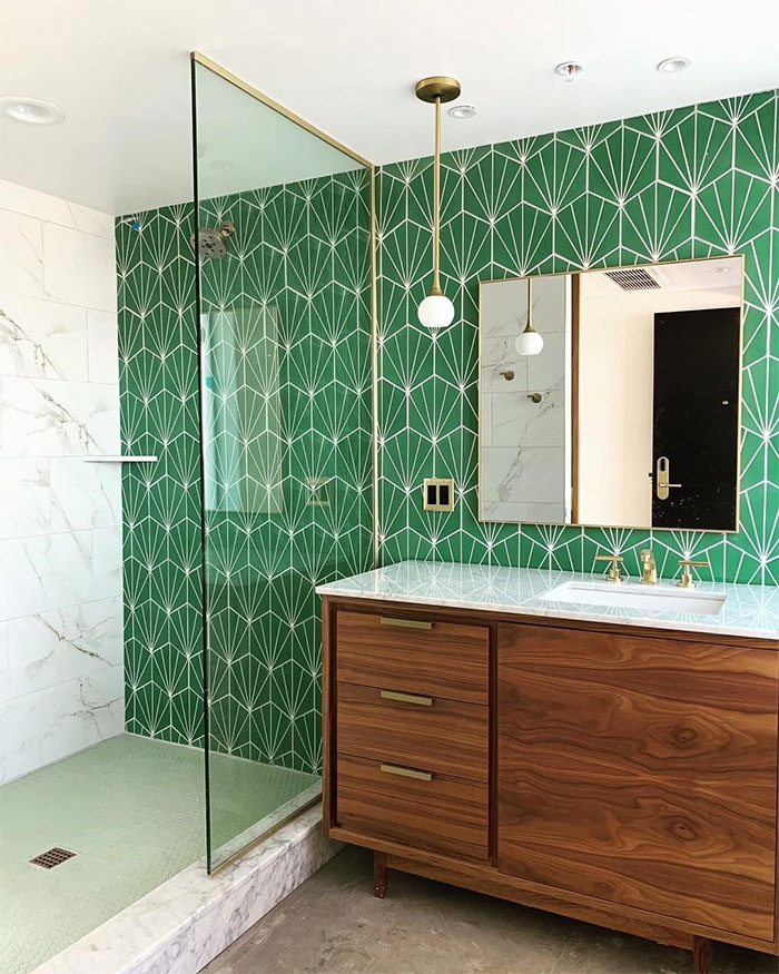 bathroom with green tropical tiles and sink