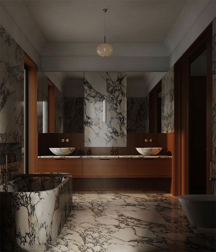 dark bathroom with patterned marble tiles and wooden cabinets