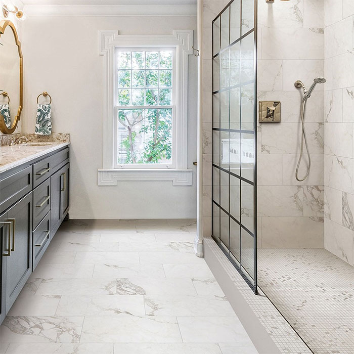 bathroom with white marble tiles and sink