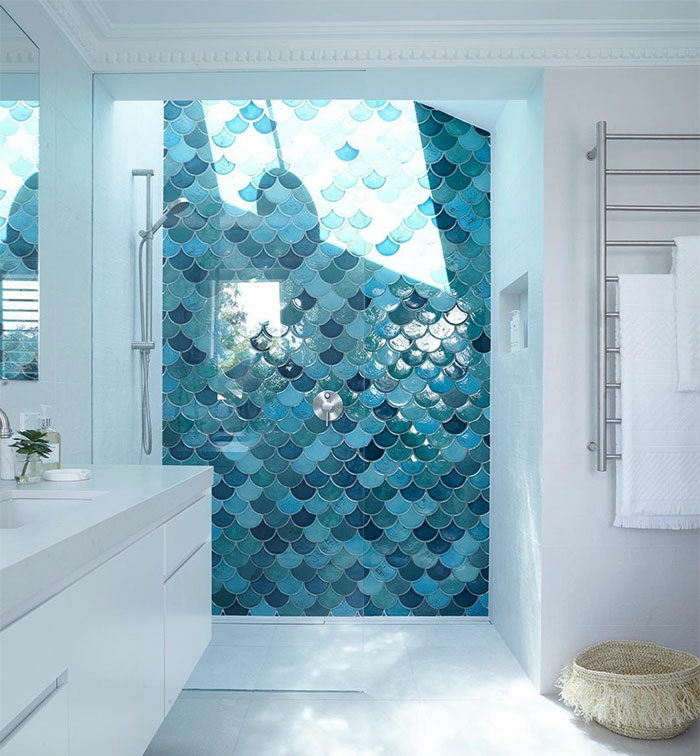 white bathroom with blue fish-scale shower tiles