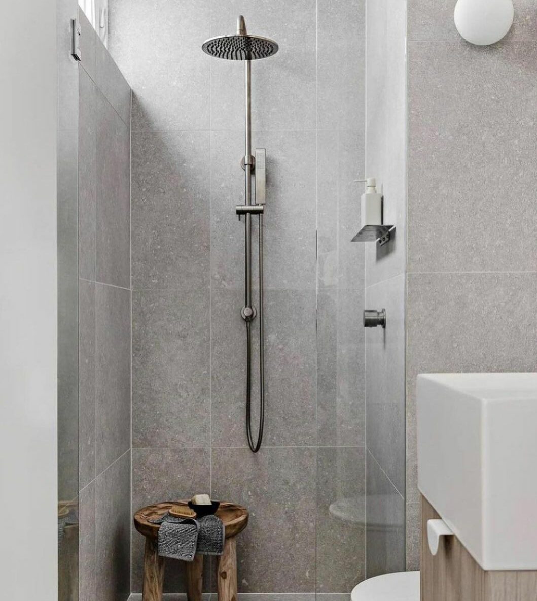 bathroom with gray limestone tiled walls