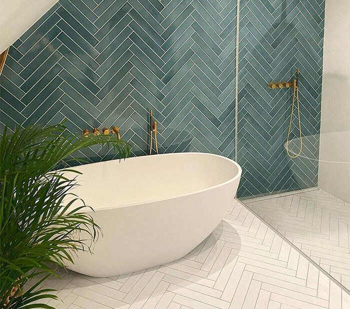 bathroom with herringbone tiles in green and white