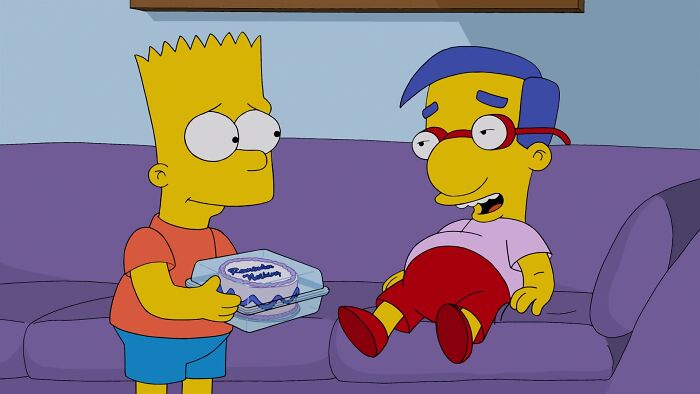 Bart holding a cake and Millhouse sitting on sofa 