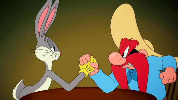Bugs Bunny and Yosemite Sam arm wrestling 