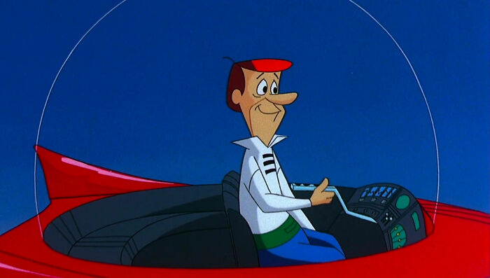 George Jetson in a flying red car 