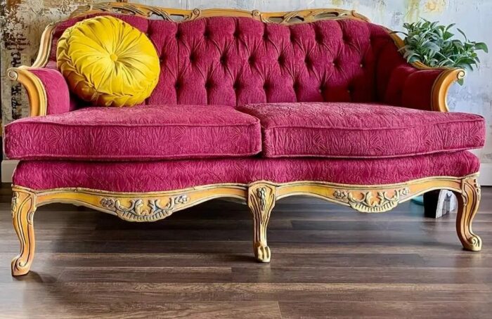 Purple chalk-painted sofa with a yellow pillow
