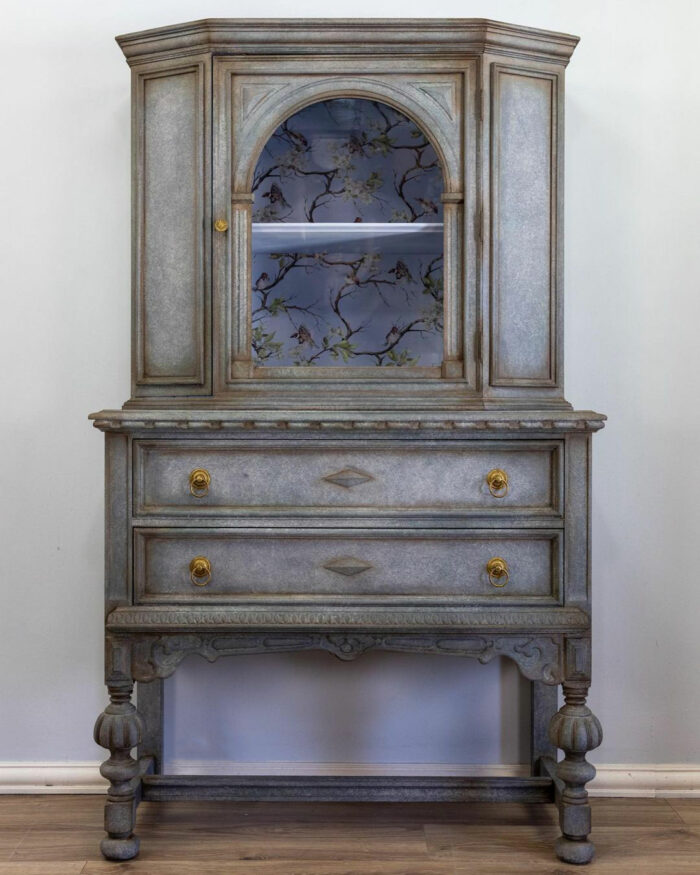 A dark gray and blue chalk-painted antique cupboard