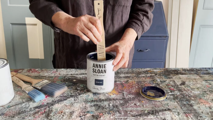 A person mixing Annie Sloan chalk paints