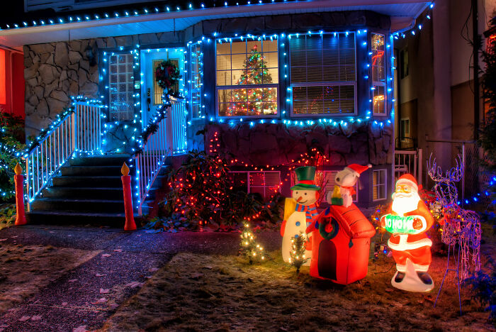 Snowman and santa claus near house