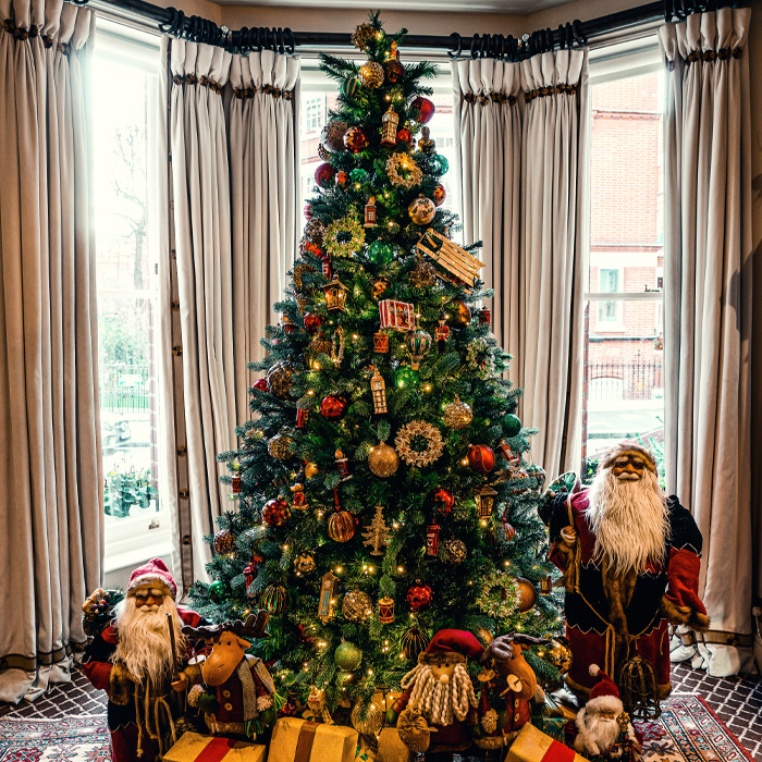 Christmas tree between Santa Clause dolls