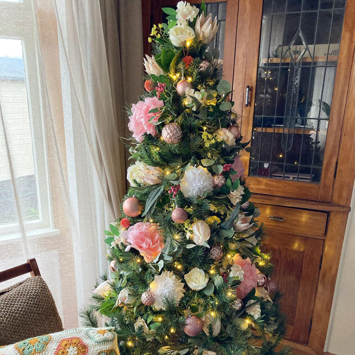 Christmas tree decorated by flowers 