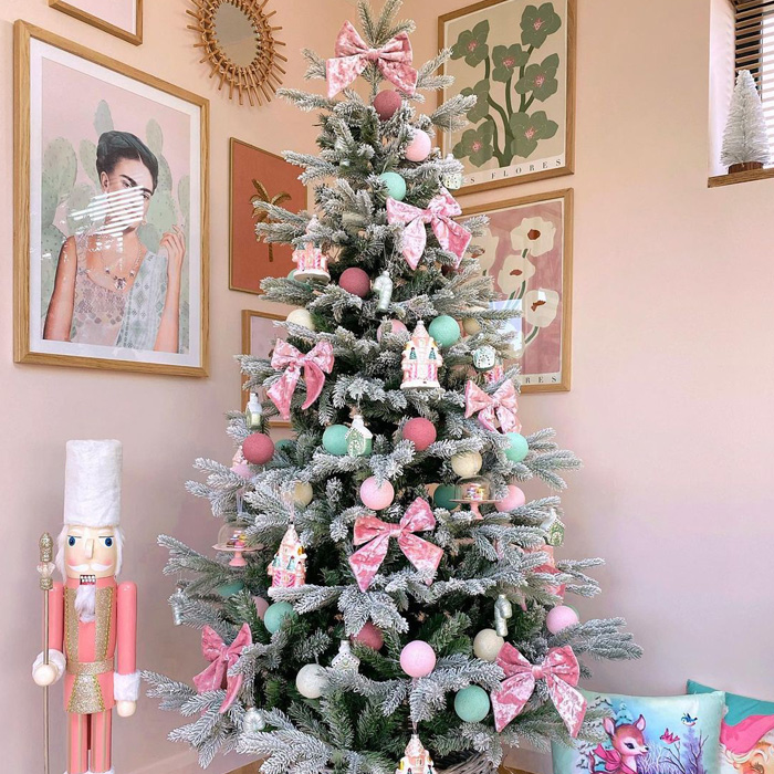 Christmas tree with pink bows in the corner 