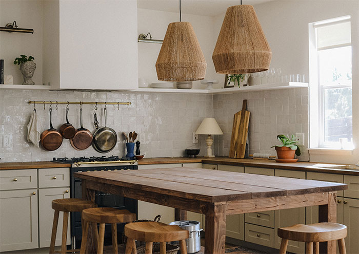 Country kitchen with white cupboards and old table