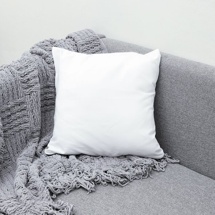 White pillow on gray sofa