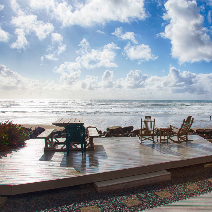 Wooden deck with furniture with ocean view on the beach 