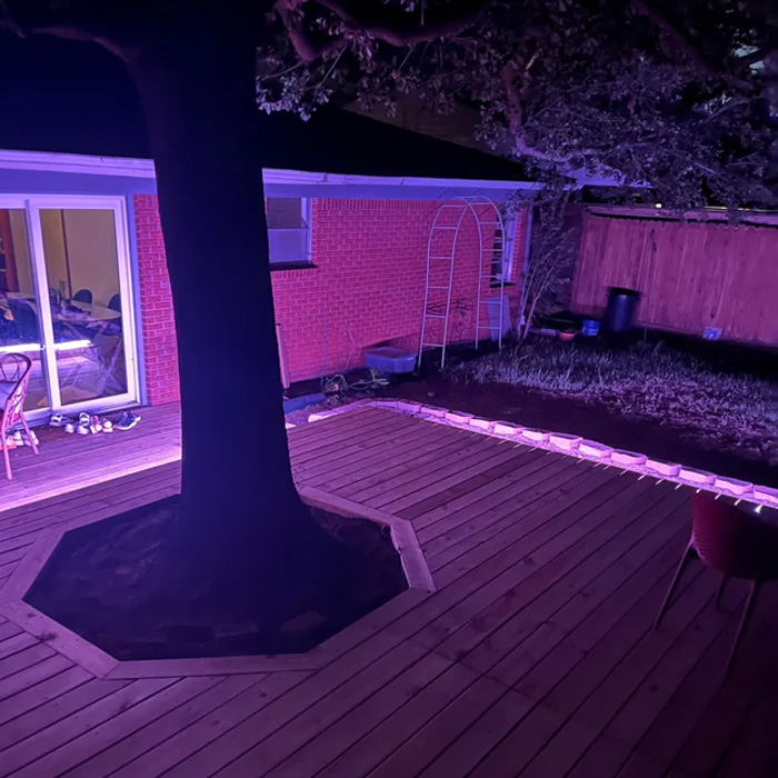Deck built around a large tree illuminated at night, showcasing creative backyard deck ideas for enhancing outdoor time. Deck built around a large tree illuminated at night, showcasing creative backyard deck ideas for enhancing outdoor time.