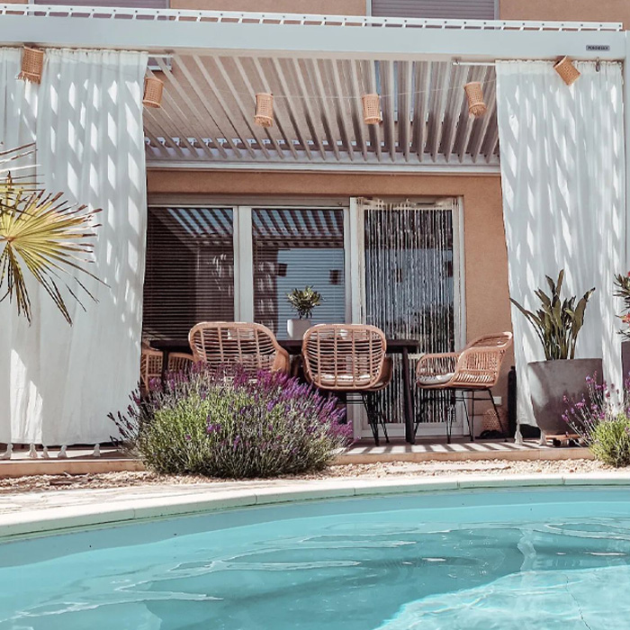 Deck with curtains and wicker chairs by the swimming pool showcasing creative backyard deck ideas for outdoor relaxation. Deck with curtains and wicker chairs by the swimming pool showcasing creative backyard deck ideas for outdoor relaxation.