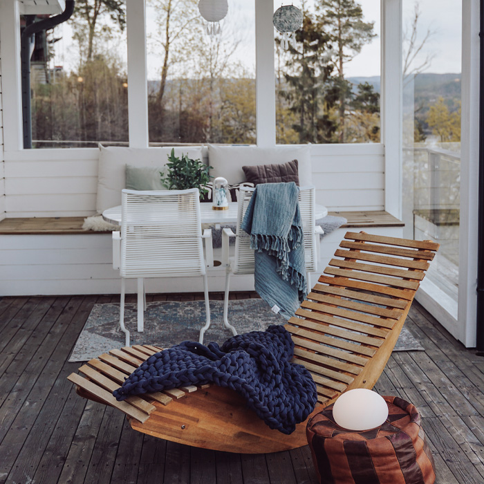 Wooden armchair with blanket on it 
