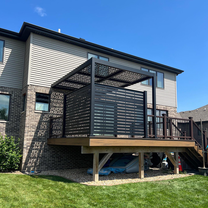 Modern backyard deck with a privacy screen and pergola providing a stylish outdoor living space to enhance your time outdoors Modern backyard deck with a privacy screen and pergola providing a stylish outdoor living space to enhance your time outdoors