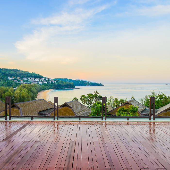 A deck on a roof with ocean view 