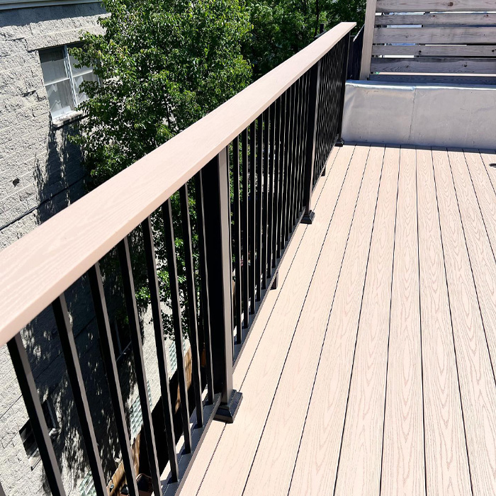 Wooden drink rail attached to a modern backyard deck railing enhancing outdoor living space design. Wooden drink rail attached to a modern backyard deck railing enhancing outdoor living space design.