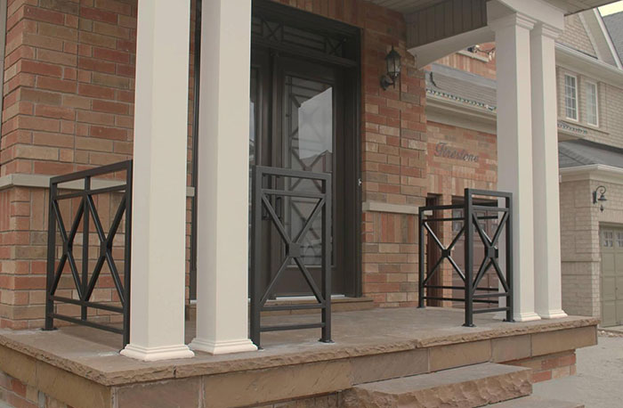 Black metal deck railing with criss-cross design on a front porch enhancing exterior deck railing ideas. Black metal deck railing with criss-cross design on a front porch enhancing exterior deck railing ideas.