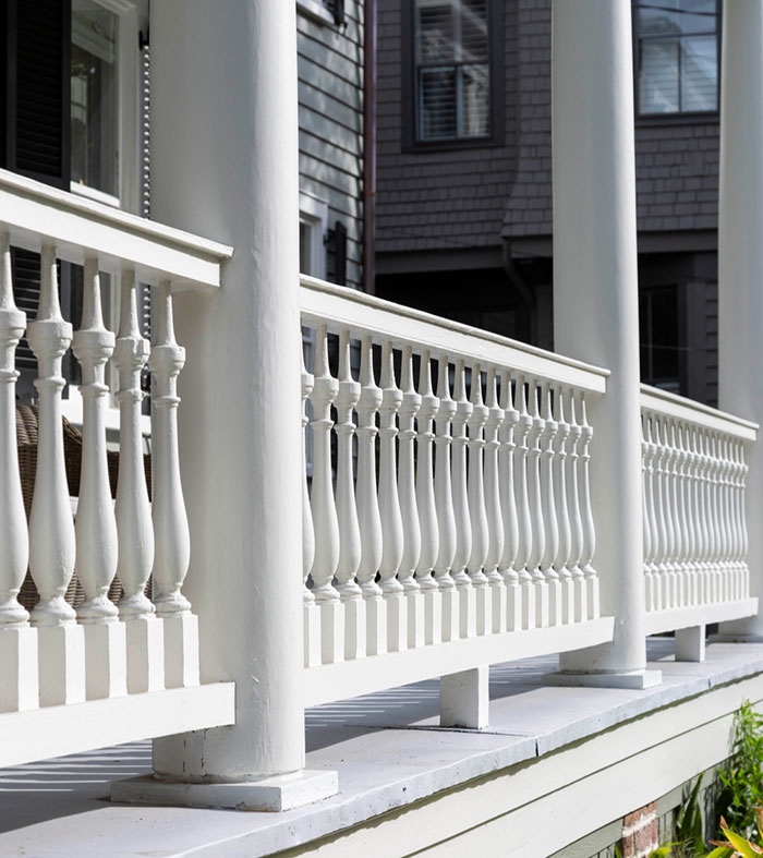 White colonial deck railing featuring classic balusters and sturdy columns enhancing exterior deck design ideas. White colonial deck railing featuring classic balusters and sturdy columns enhancing exterior deck design ideas.