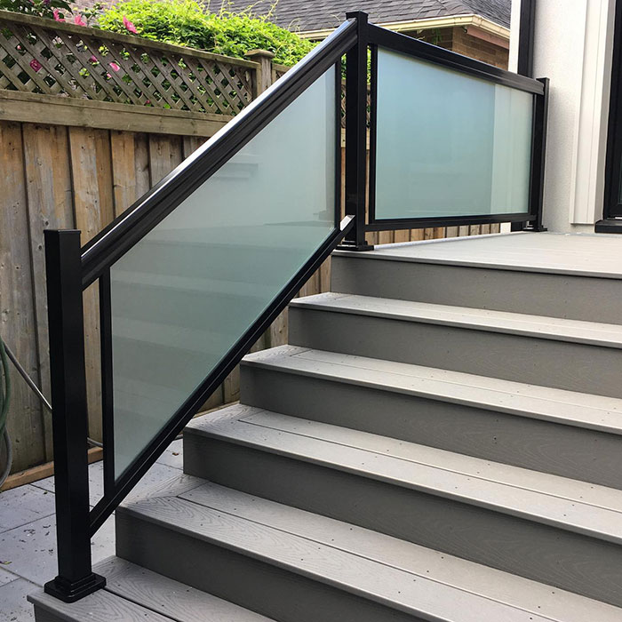 Black deck railing with blurred glass panels enhancing modern deck railing ideas and designs outdoors. Black deck railing with blurred glass panels enhancing modern deck railing ideas and designs outdoors.