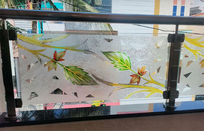 Colorful glass deck railing featuring leaf designs, adding a vibrant and artistic touch to exterior deck spaces. Colorful glass deck railing featuring leaf designs, adding a vibrant and artistic touch to exterior deck spaces.
