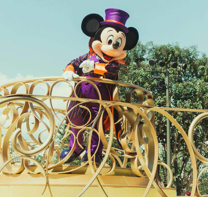 Person wearing Mickey Mouse suit
