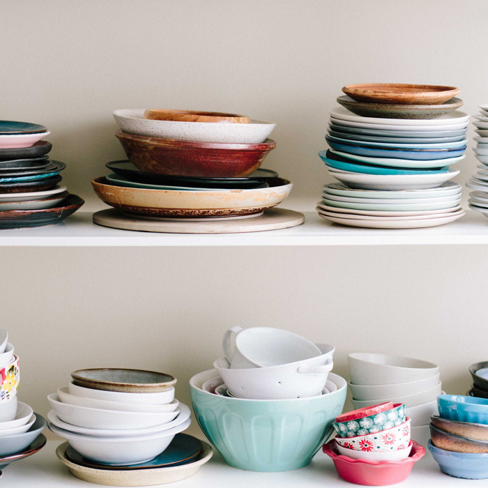 Ceramics bowls on the white shelf 