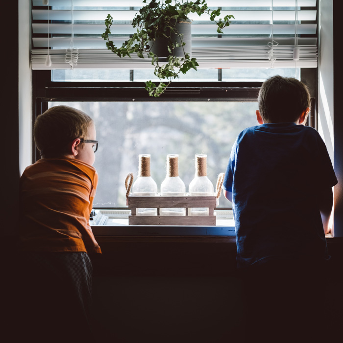 Two boys looking out of the window 