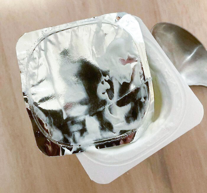 A Witch With A Black Hood Hidden Under The Lid Of My Yogurt