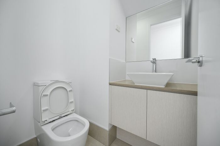 white bathroom with white toilet