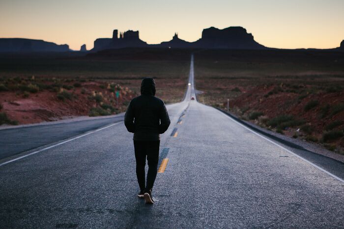 man walking one the road