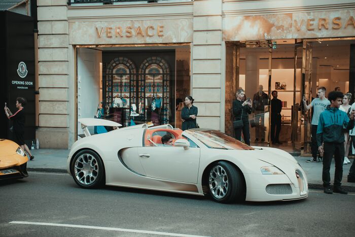 White luxury car with crowd