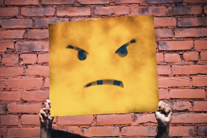 Angry face painted on yellow paper