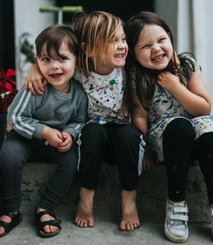 Kids sitting on floor and smiling